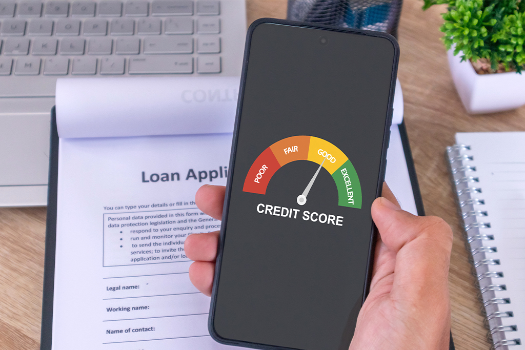 Credit Score 101: Everything You Must Know Person checking good credit score on phone over loan form, showing financial health with FatakPay.
